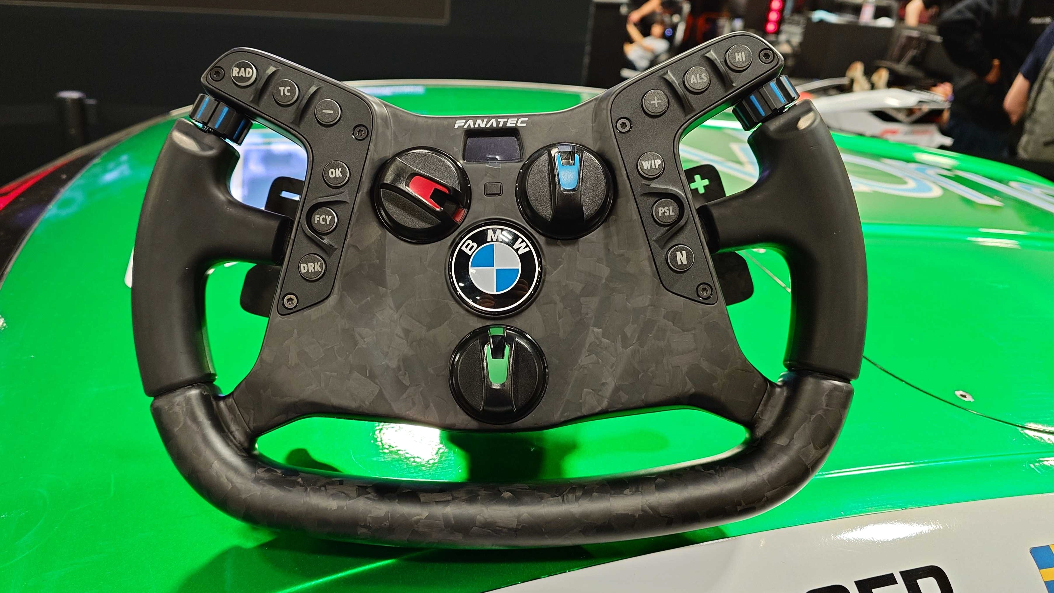 A photo of the Fanatec Podium BMW M4 GT3 racing wheel on top of a BMW M4 GT3 race car.