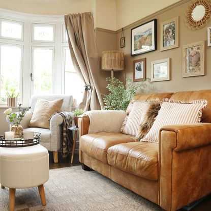 A small living room painted in a soft brown shade with a brown leather sofa