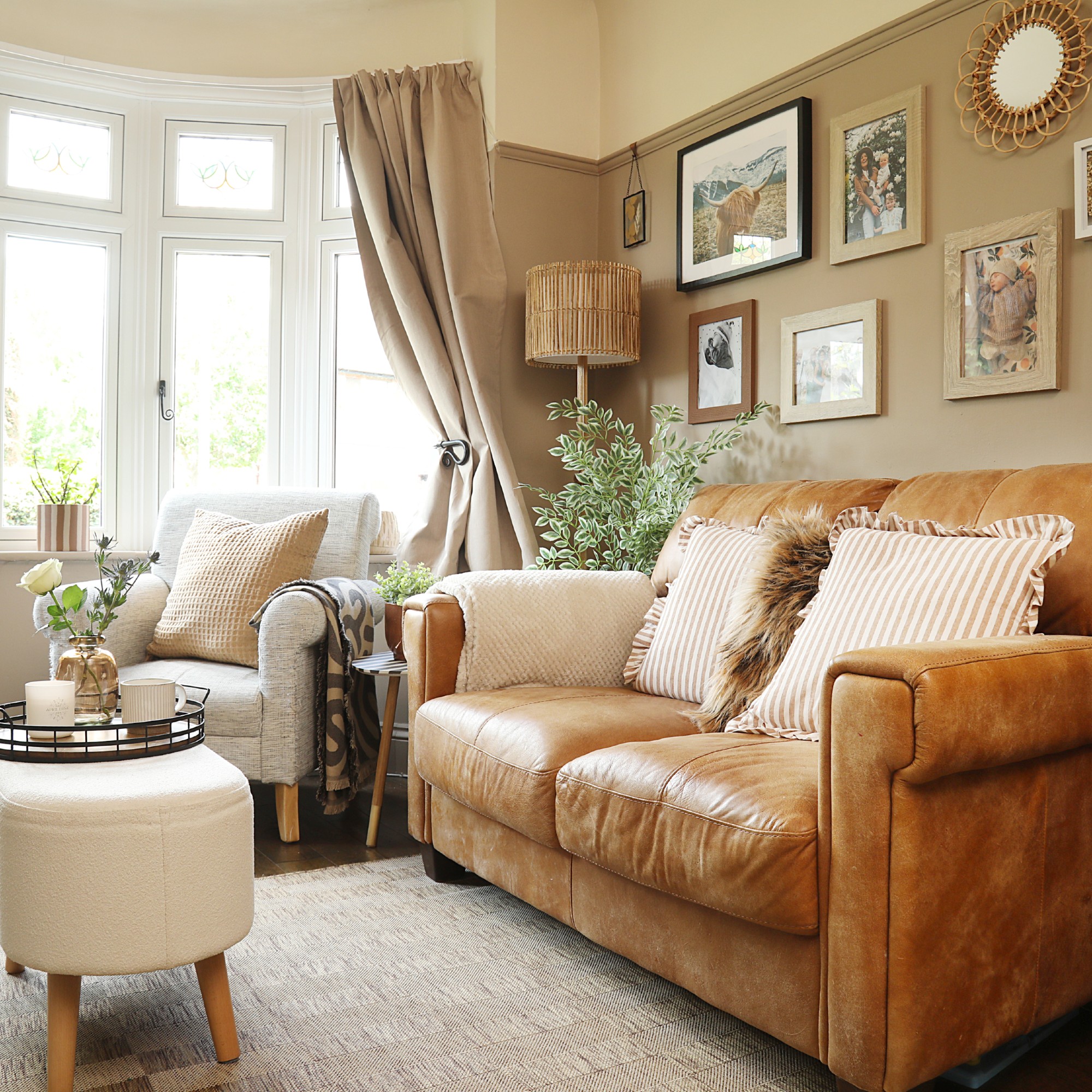 A small living room painted in a soft brown shade with a brown leather sofa