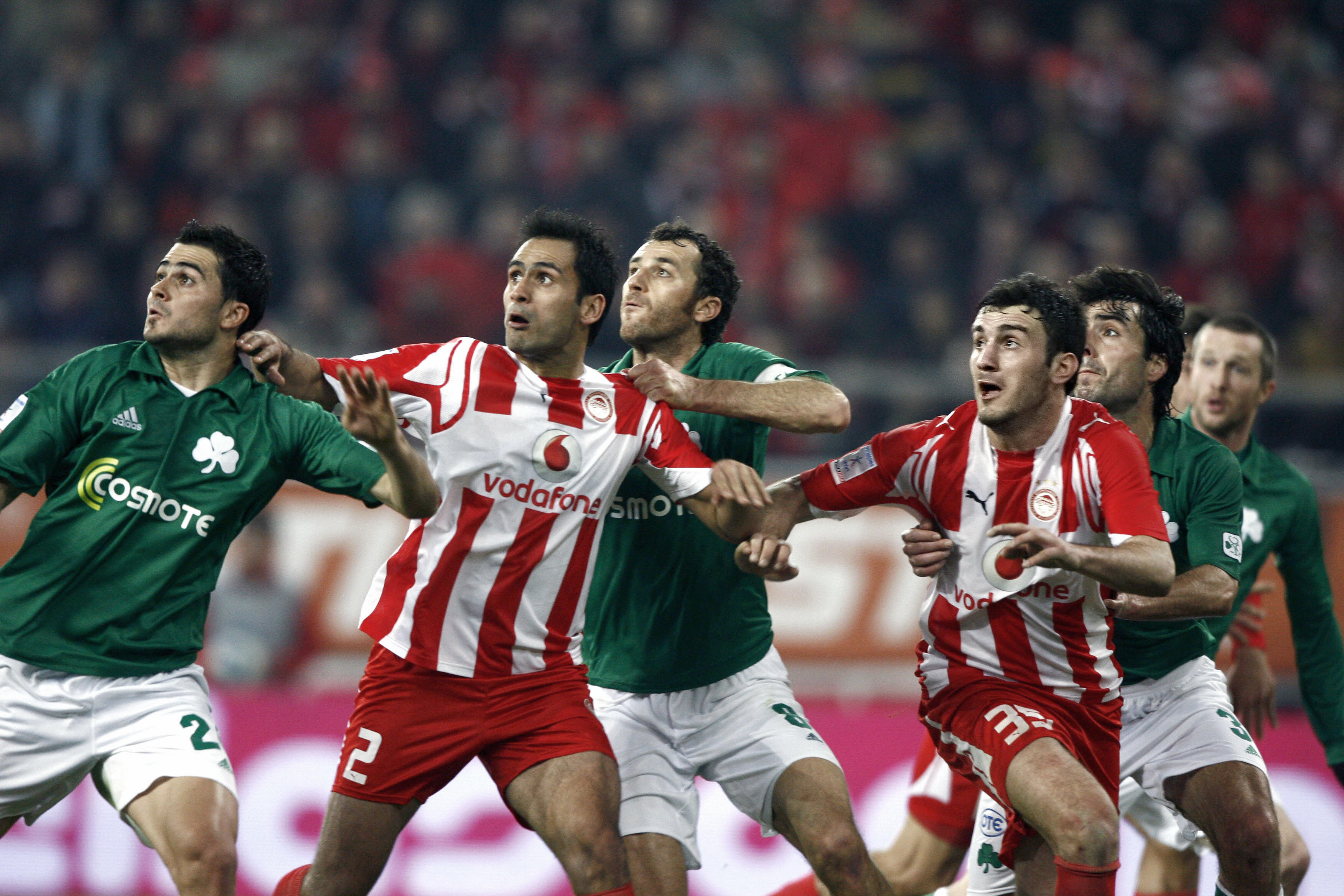 Olympiacos and Panathinaikos players compete for the ball in a match in January 2008.