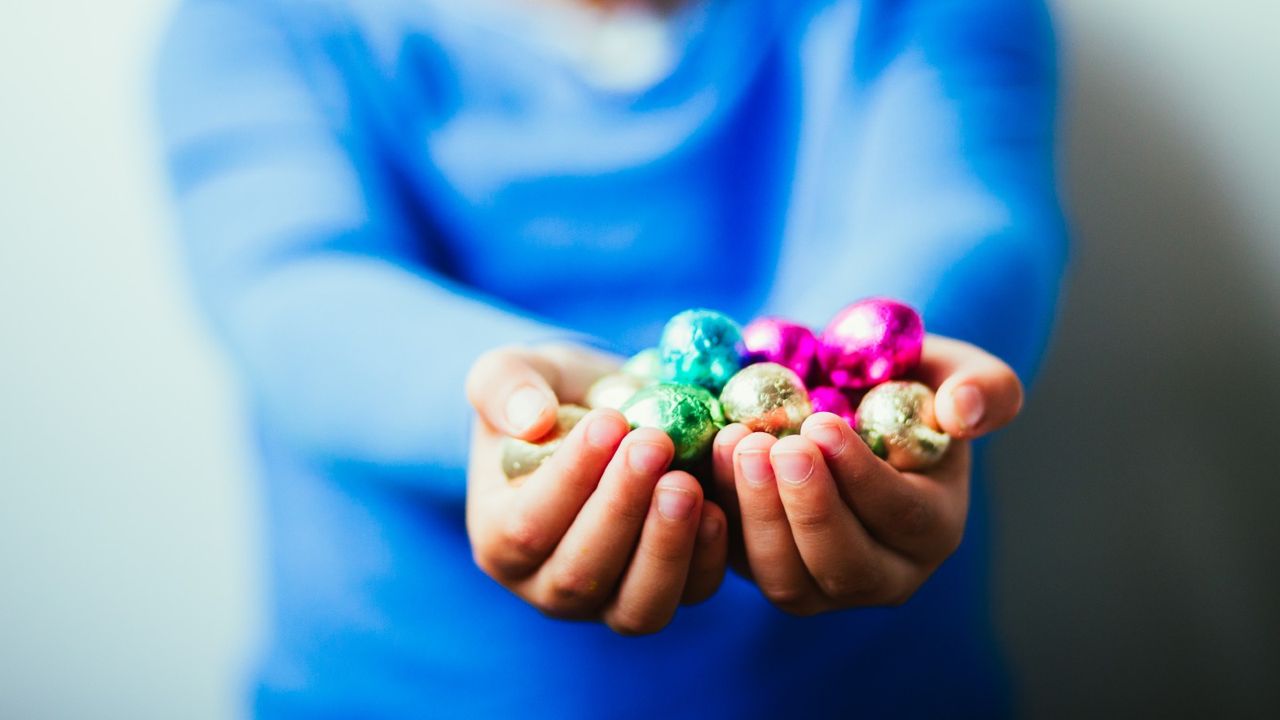 child with small with chocolate easter eggs