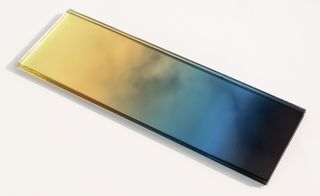 A glass slab with a yellow, blue and black gradient colour.