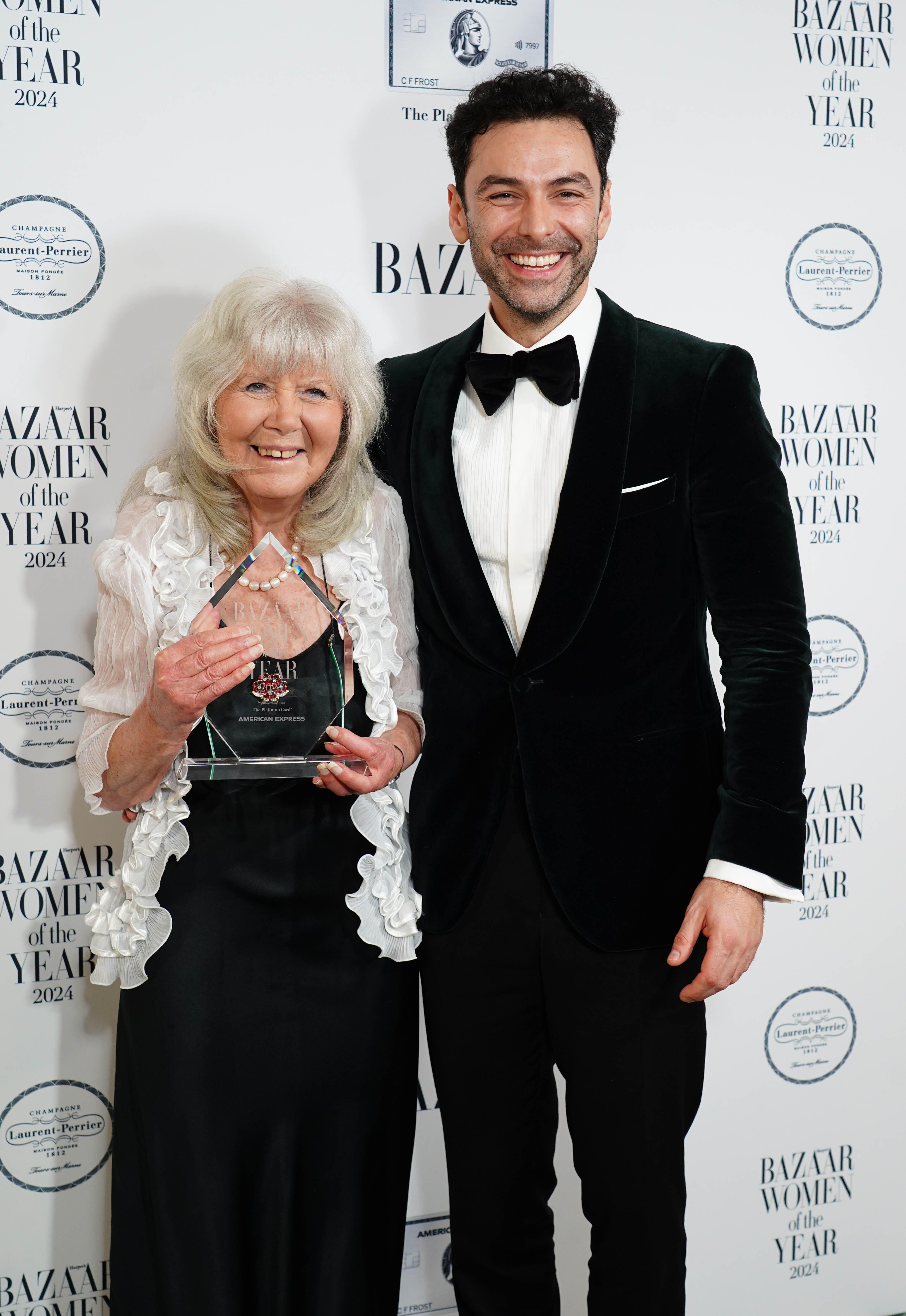 Aidan Turner with Dame Jilly Cooper winning the Writers Award at the Harper's Bazaar Women of the Year 2024 awards, at Claridges in London.