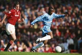 MANCHESTER, UNITED KINGDOM - MAY 08: Coventry City striker Peter Ndlovu outpaces Manchester United defender Gary Pallister during a FA Premier League match between Manchester United and Coventry City at Old Trafford on May 8, 1994 in Manchester, England. (Photo by David Cannon/Allsport/Getty Images)