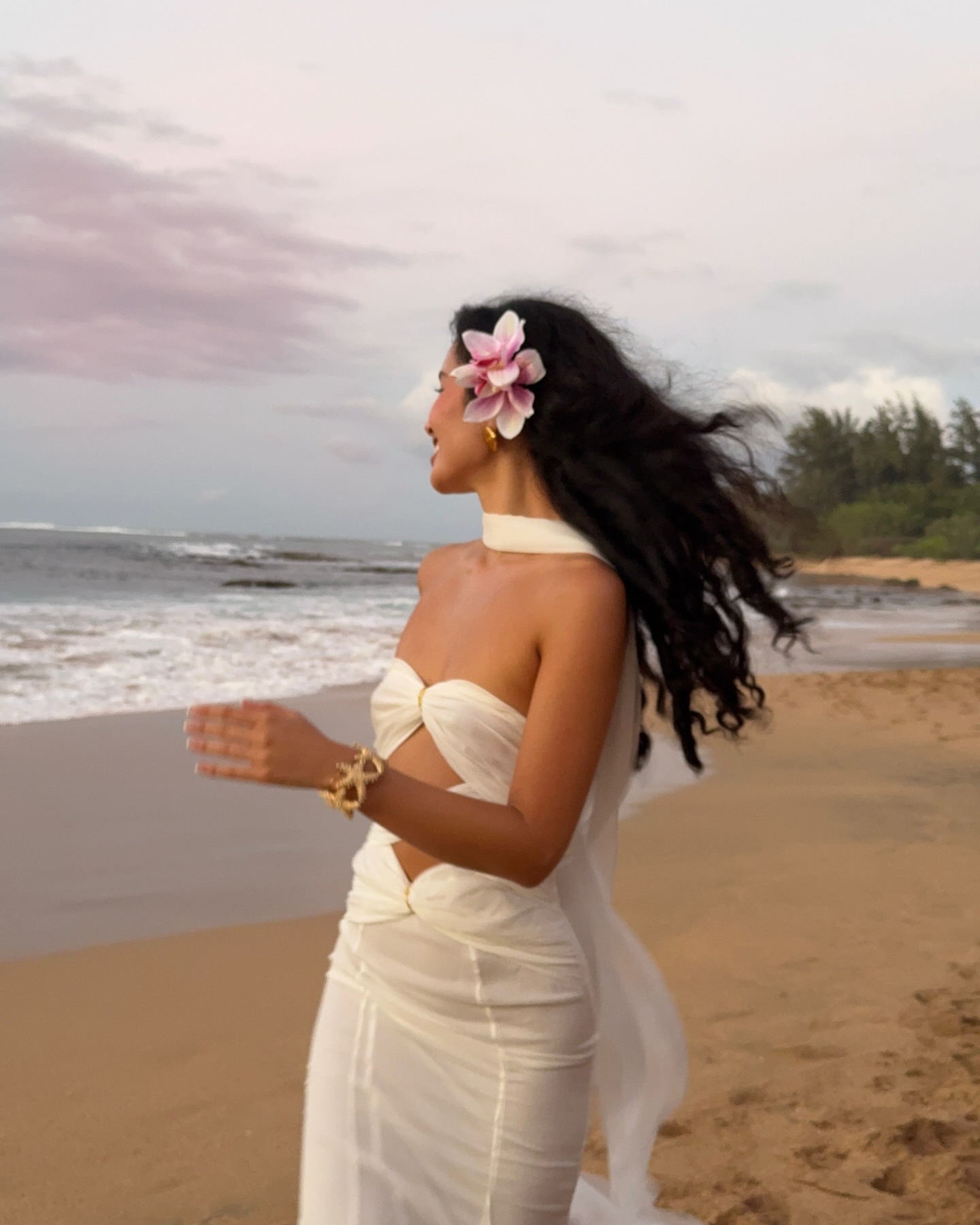 Woman running on the beach with wavy, flowing hair.