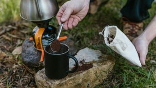 Coffee being spooned into cup