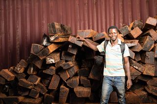 An ebony supplier with ebony billets at the Crelicam sawmill in Yaoundé, Cameroon.