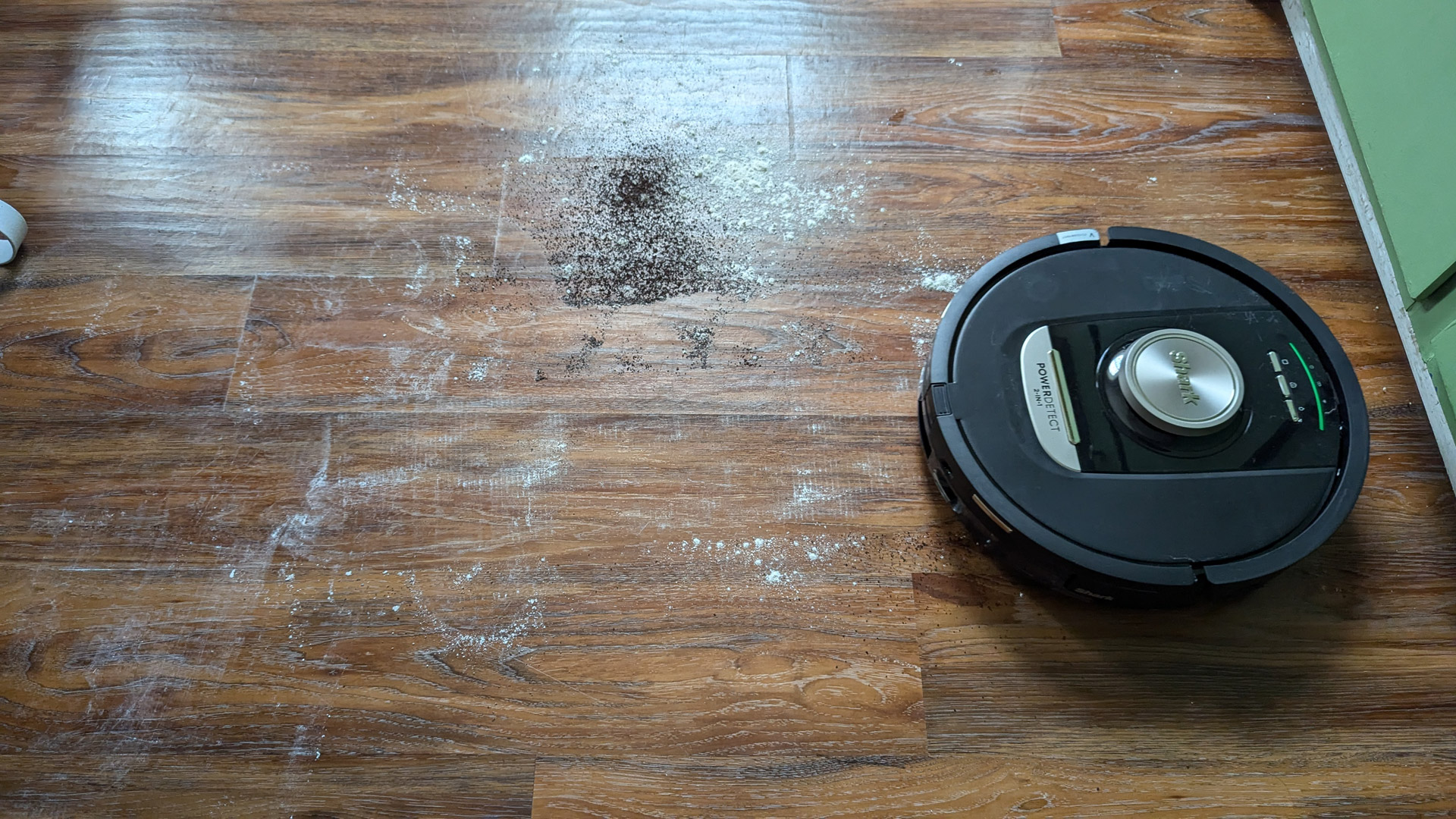 The Shark PowerDetect Robot Vacuum and Mop cleaning up flour and coffee