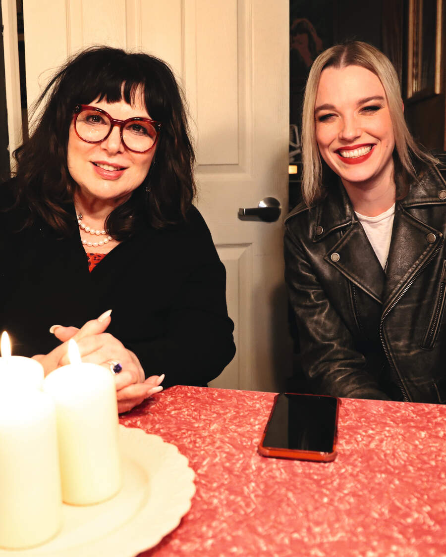 Ann Wilson and Lzzy Hale seated at a table