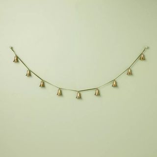 5' Decorative Brass Bell Christmas Garland against a green background.