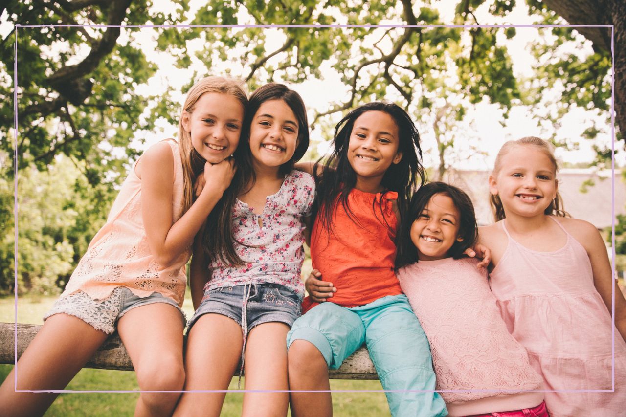 Group of tween girls with their arms around each other