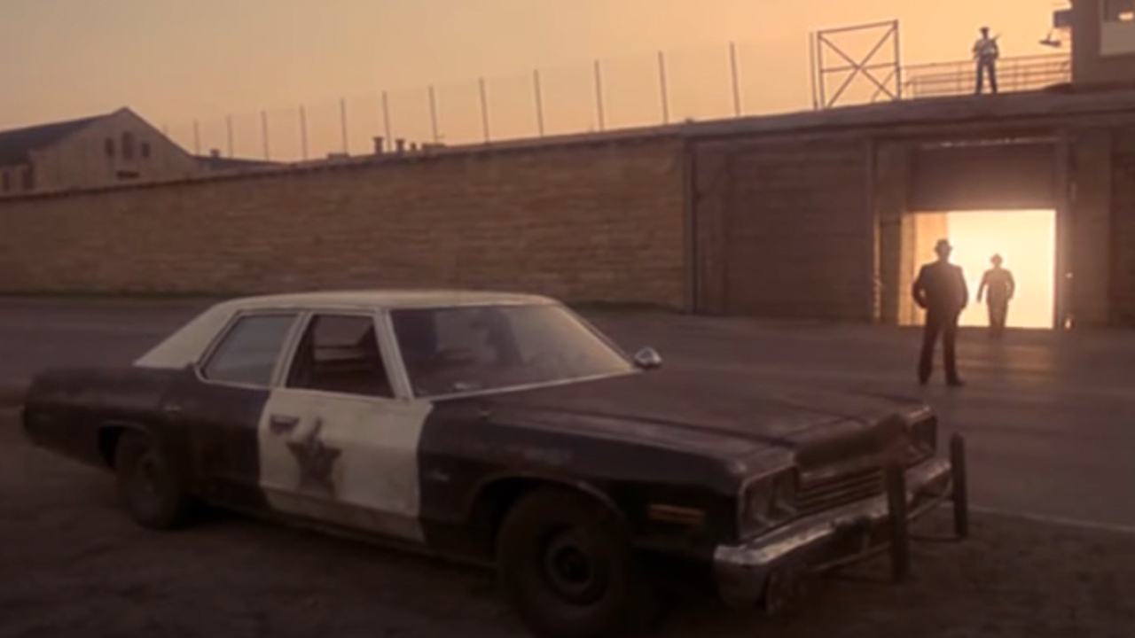 The Bluesmobile parked in front of a prison.