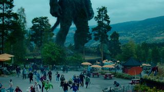 People flee as the titular troll strides towards them in Netflix's Troll film