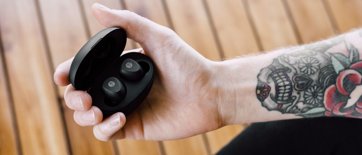 Review hero image showing Grado GT220 wireless earbuds held in hand