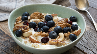 Nuts with blueberries and fig on Greek yoghurt