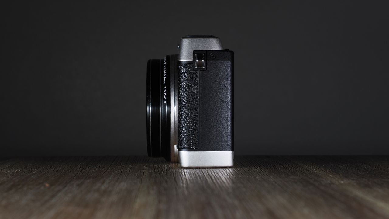 Olympus Stylus SH-3 on a wooden surface