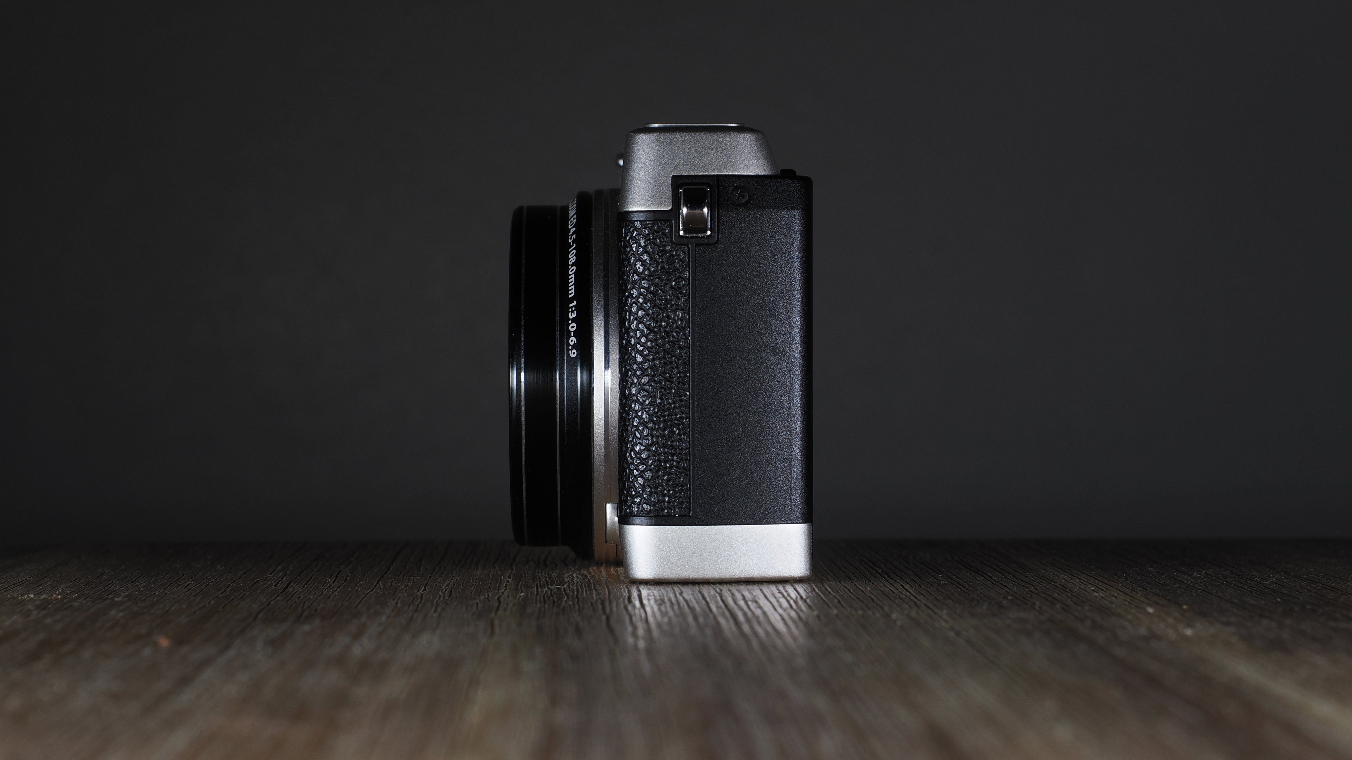 Olympus Stylus SH-3 on a wooden surface