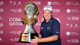 Finnish golfer Sami Valimaki holds up the Qatar Masters trophy after winning the 2023 event in a playoff over Jorge Campillo