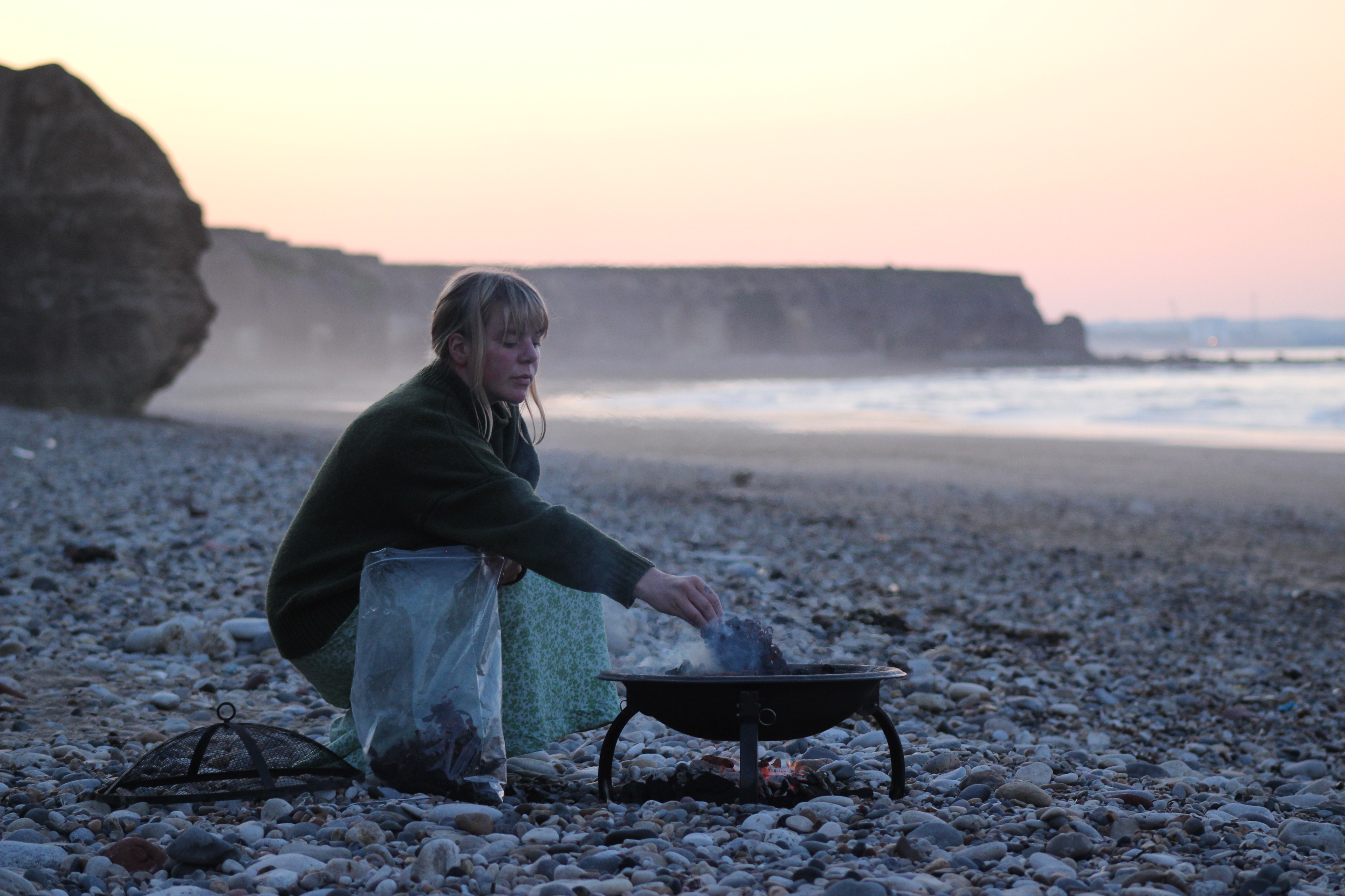 Lulu Harrison creating seaweed ash for glassmaking on the Northumberland coast
