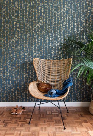 boho style living room with wallpaper, rattan chair, plant