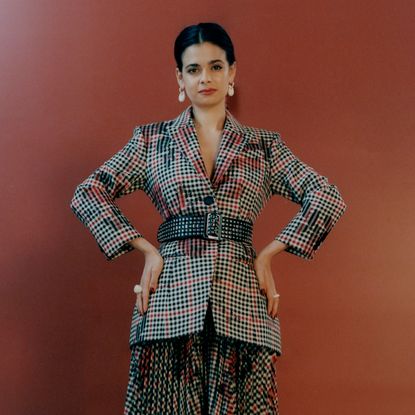  Erdem blazer and skirt; Tory Burch belt; Dinosaur Designs earrings, rings.