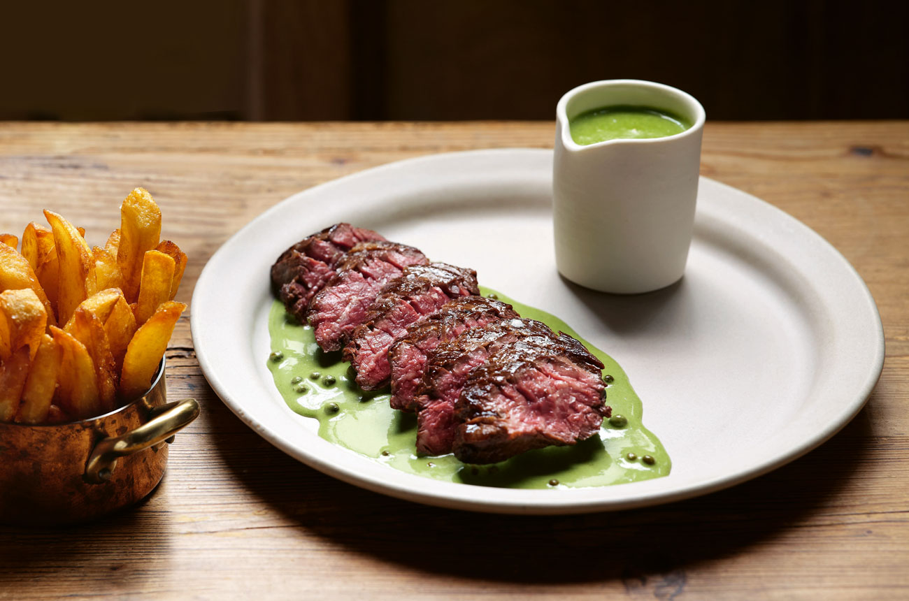 Onglet steak with green peppercorn sauce served with chips