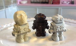 Three chocolate robot figurines.