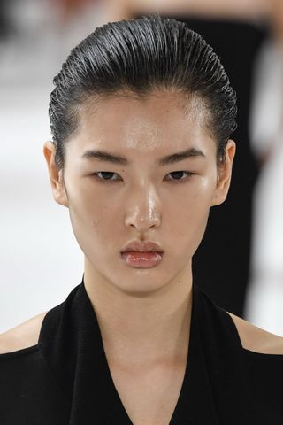 Model at Sportmax wearing skin gloss, a key Spring/Summer 2025 fashion month beauty look