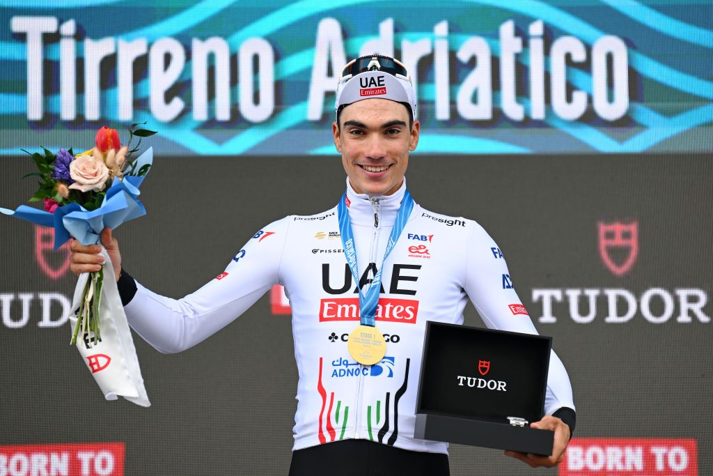 LIDO DI CAMAIORE ITALY MARCH 04 Juan Ayuso of Spain and UAE Emirates Team celebrates at podium as stage winner during the 59th TirrenoAdriatico 2024 Stage 1 a 10km individual trial time from Lido di Camaiore to Lido di Camaiore UCIWT on March 04 2024 in Lido di Camaiore Italy Photo by Tim de WaeleGetty Images