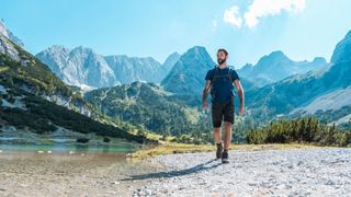 A man hiking between mountains