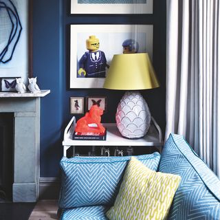 Blue walls and sofa with yellow cushion