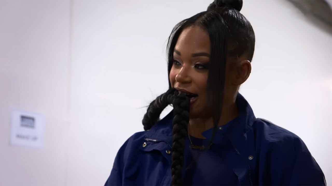 A shot of Bianca Belair holding her braid in her mouth backstage at Wrestlemania in 2025.