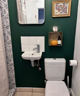 dark green shower room with white bathroom suite