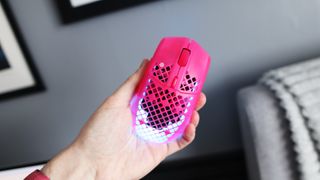 The SteelSeries Aerox 3 Wireless Gen 2 looking excellent in pink on a grey mousepad.