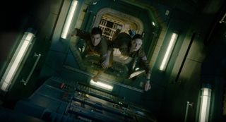 Astronauts David Jordan (Jake Gyllenhaal) and Miranda North (Rebecca Ferguson) float weightlessly through a corridor of the International Space Station in a scene from the movie "Life."