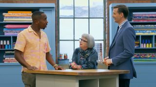"Great British Sewing Bee" host Kiell Smith-Bynoe chats with judges Esme Young and Patrick Grant in an image from season 10