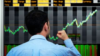 Trader watching stocks go up - stock photo