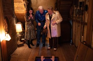 Mabel (Selena Gomez), Charles (Steve Martin), and Oliver (Martin Short) look down at a pair of hands hanging on to an attic's trap door, in 'Only Murders in the Building' season 3 finale