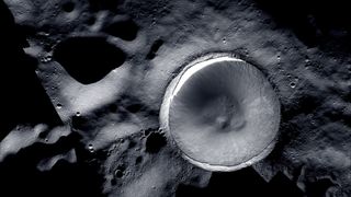 a large crater on the grey, cratered surface of the moon