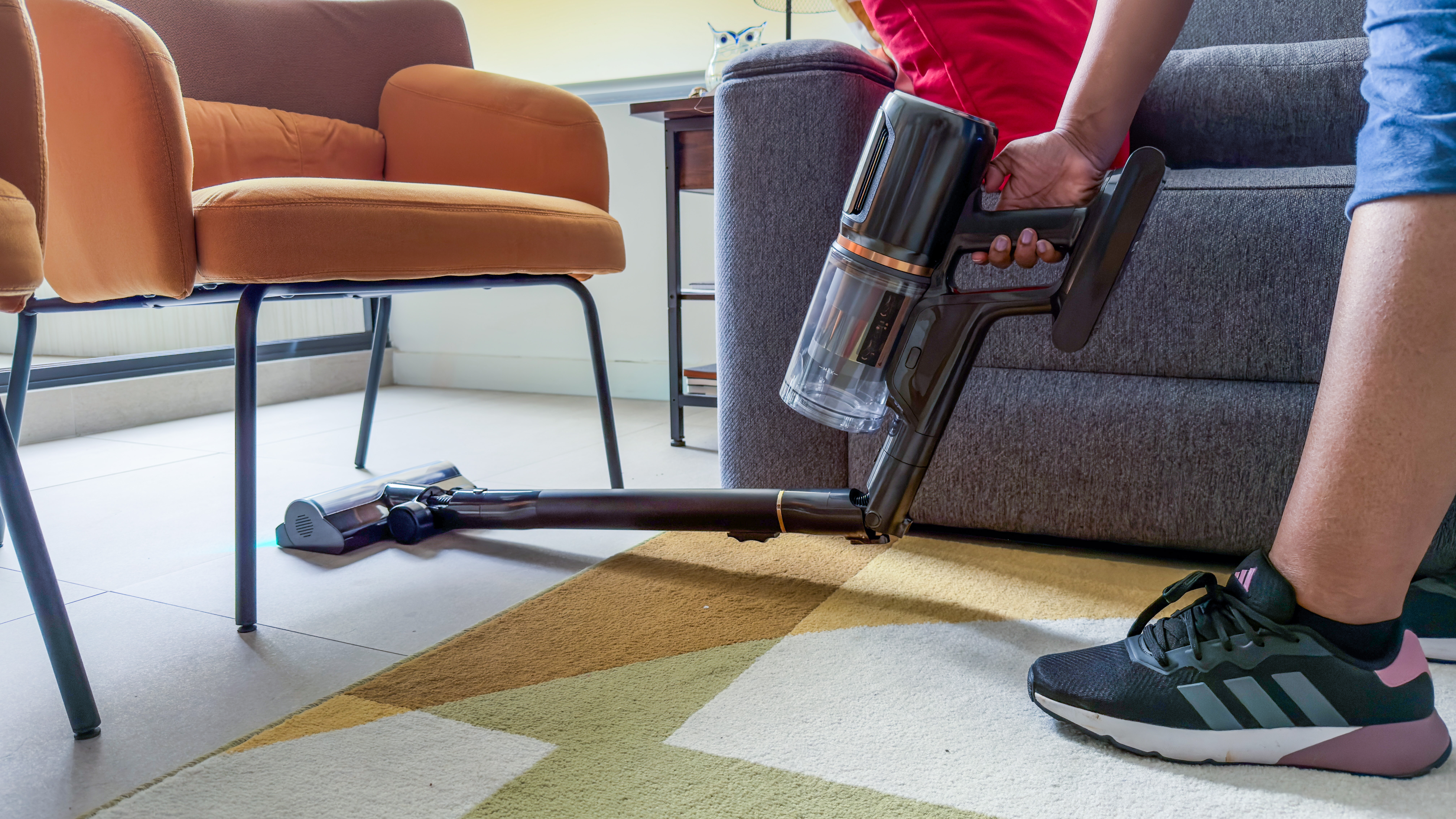 A person using the Dreame Z50 Station bent at 90 degrees under a chair