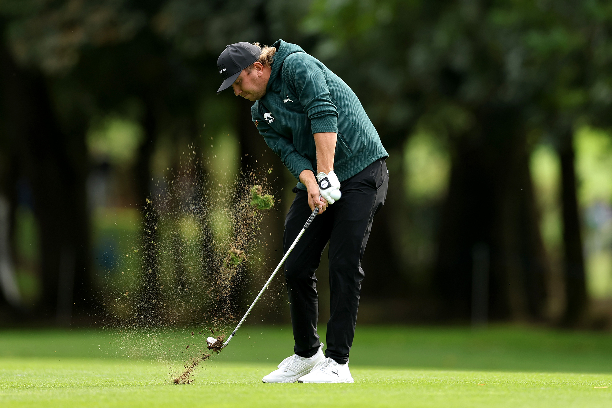 Oliver Lindell at impact with an iron, taking a divot as he moves through