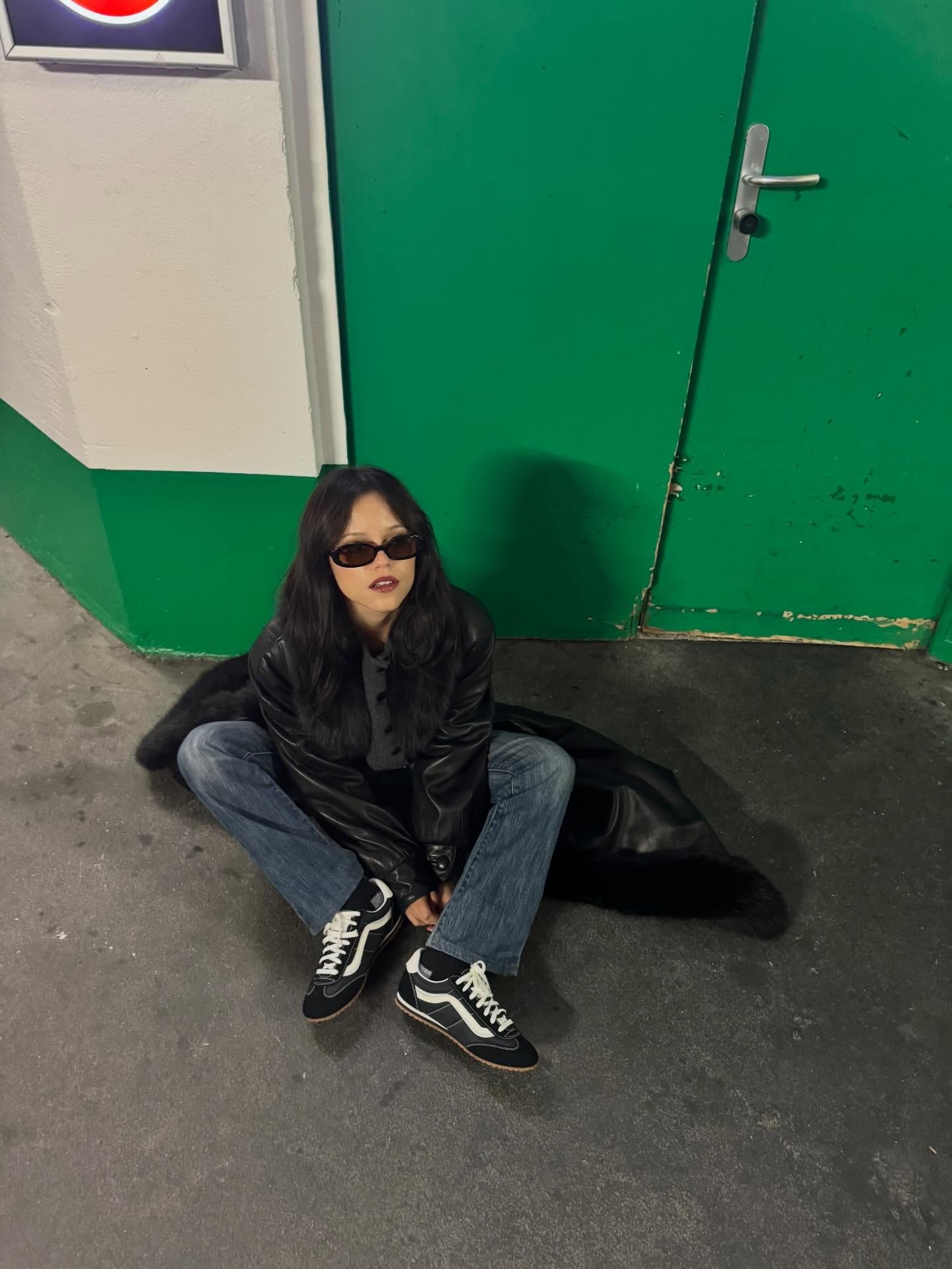 Jenna Ortega wears black Vans sneakers