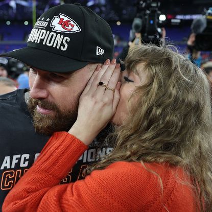 Travis Kelce and Taylor Swift celebrating the Kansas City Chiefs' win at the AFC Championship game in 2024.