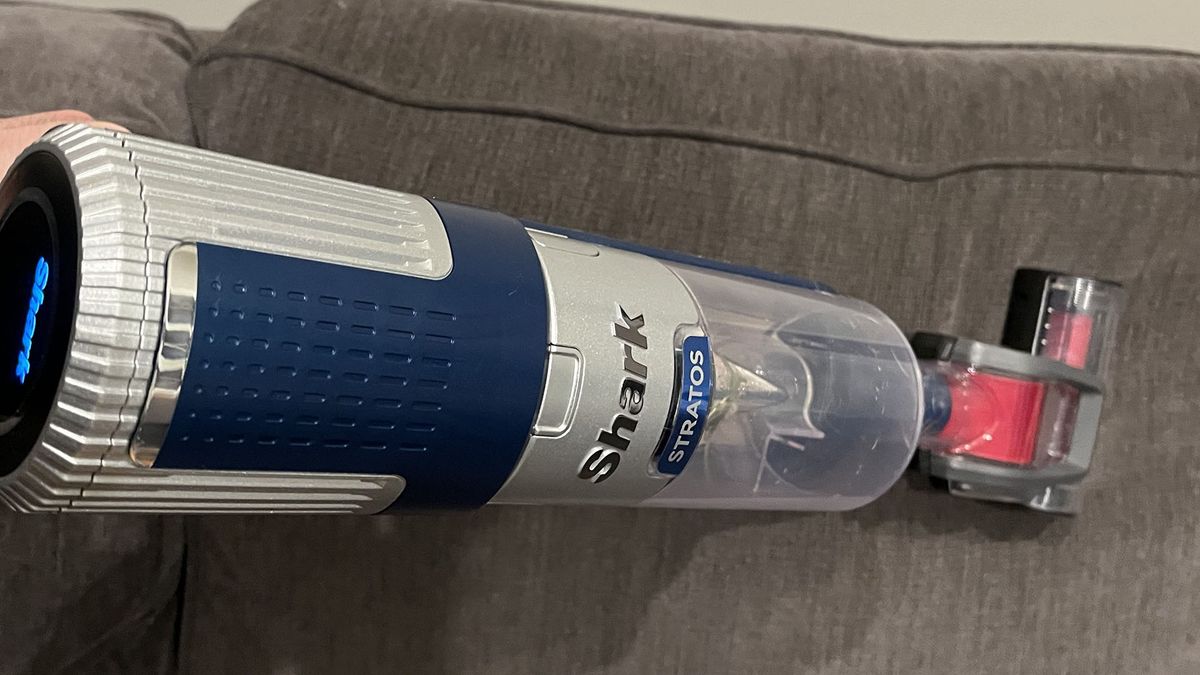 Shark Stratos Corded vacuum in handheld mode being used to clean sofa cushions