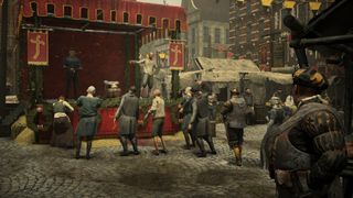 crowd gathered in front of a mummers tent in town square