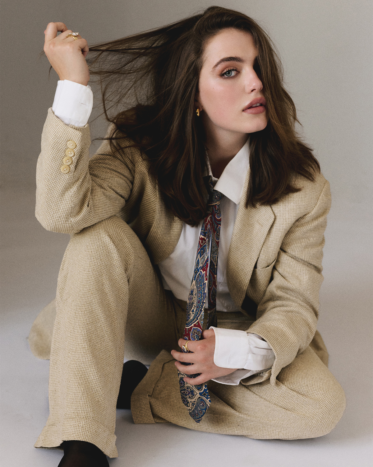 Ella Bright photographed by Zackery Michael for Who What Wear wearing a tan Ralph Lauren suit with paisley tie and gold Jenny Bird hoop earrings.
