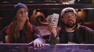 Jason Mewes smiles with intimidation as Kevin Smith makes an offer of money at the strip club in Dogma.