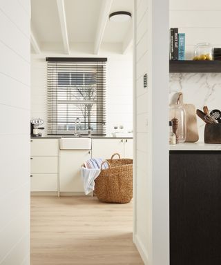 Laundry room ideas with a wooden floor and cream walls