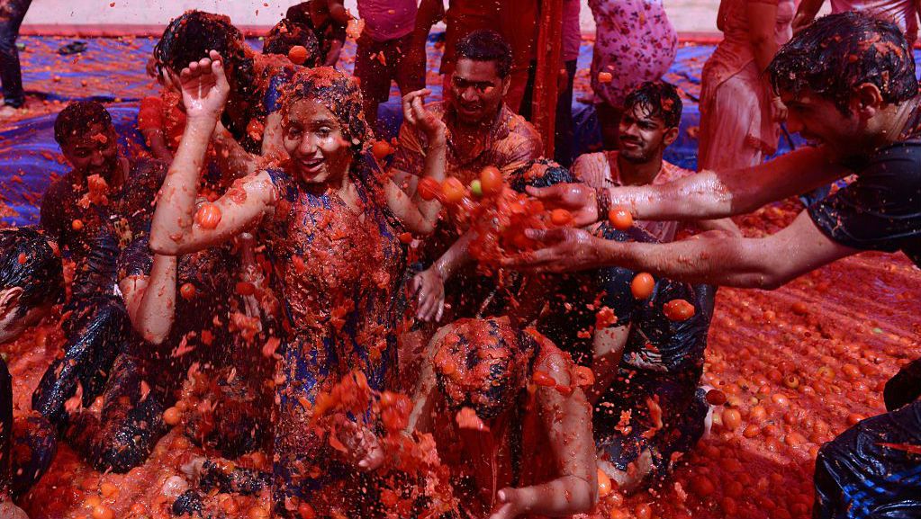 Revellers on the outskirts of Ahmedabad participate in the Holi - India's 'Tomatina' - to celebrate the coming of spring