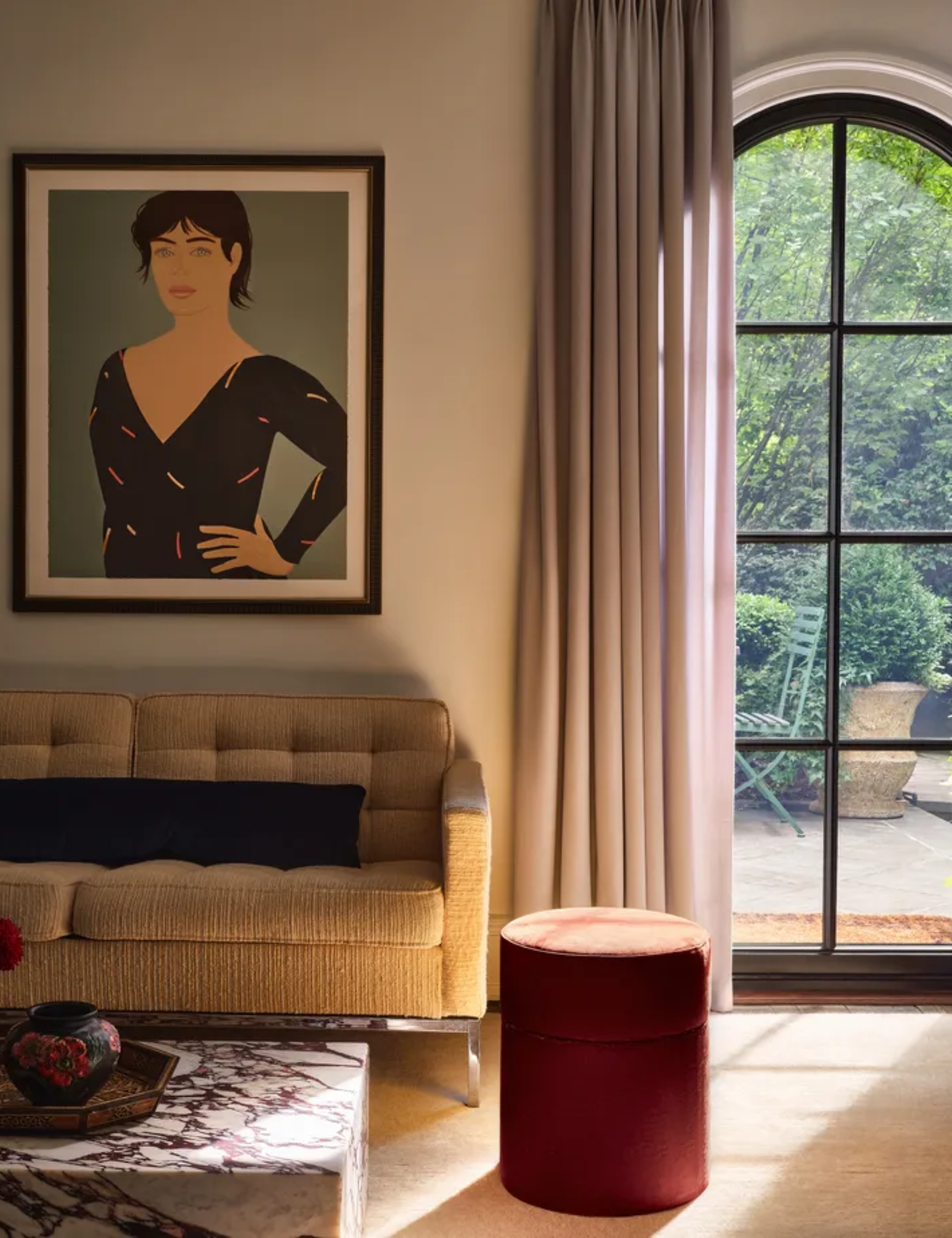 living room with gray curtain at the window and sunlight filtering in